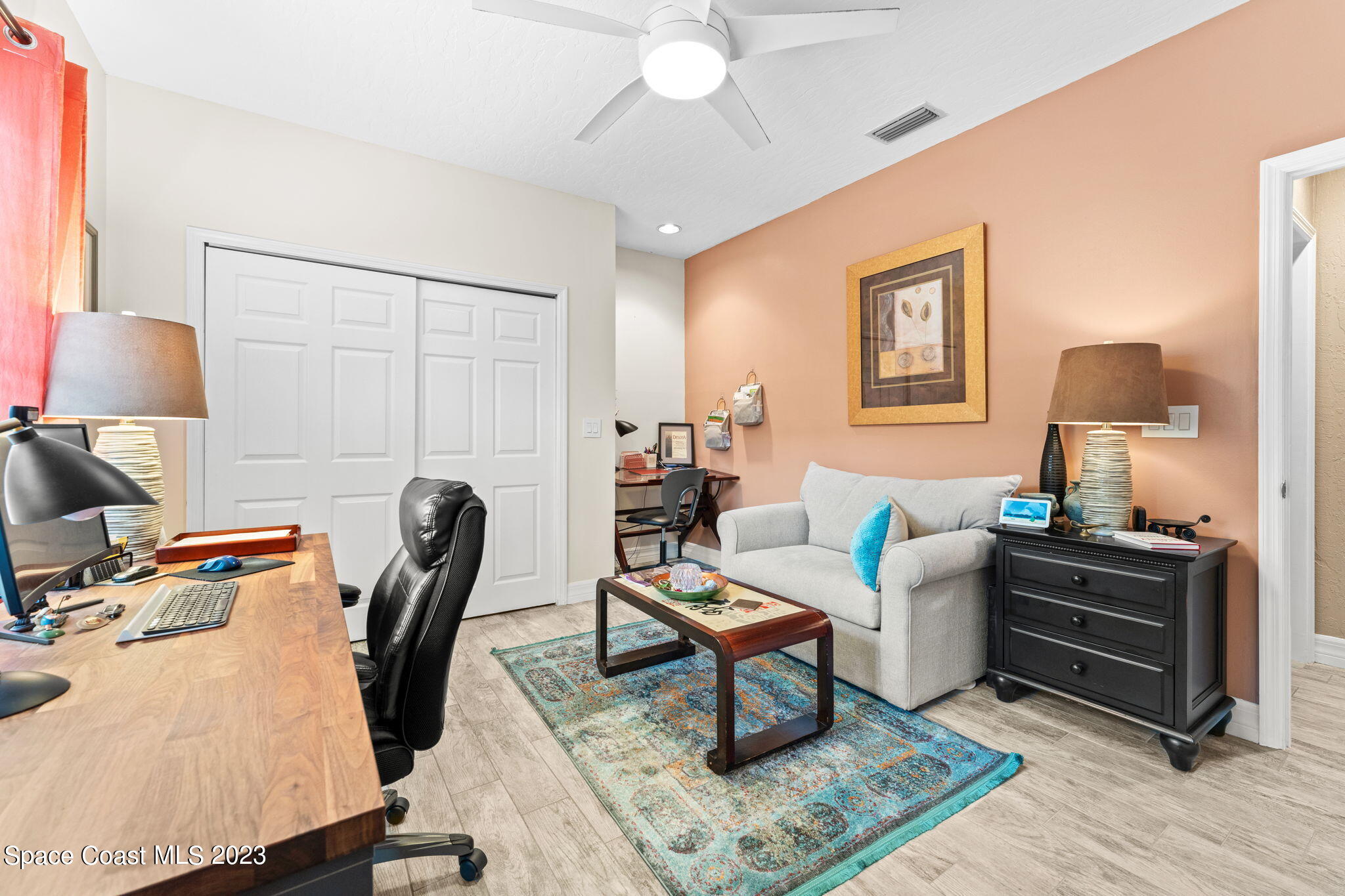 70 Lanternback Island Drive Satellite Beach, FL 32937 - Photo 11 of 26 a living room with furniture a rug and a lamp