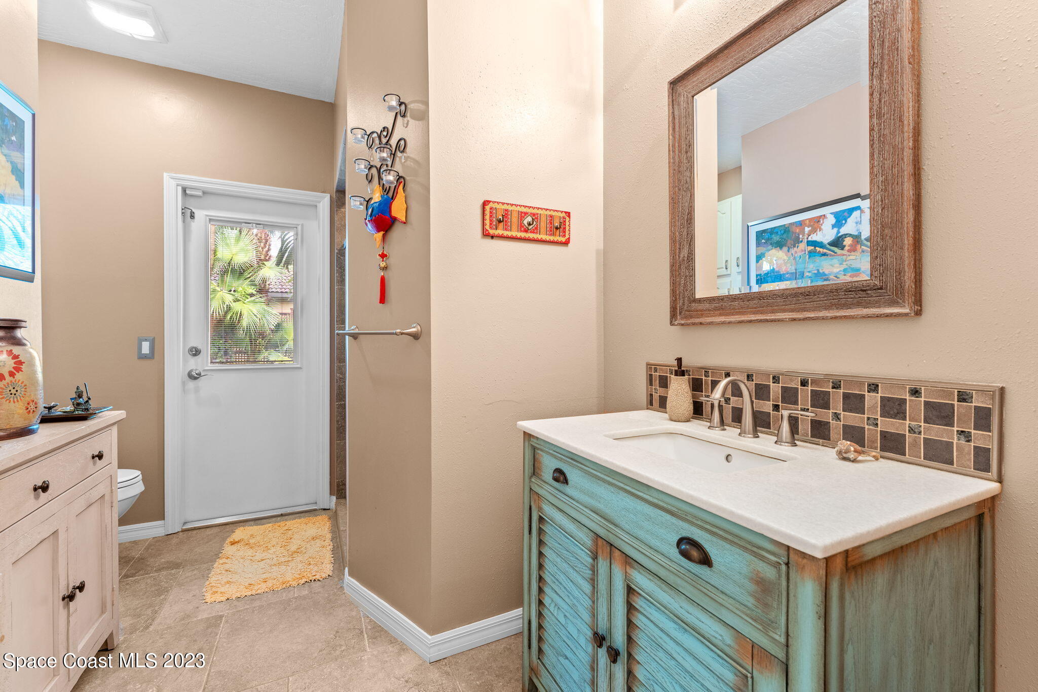70 Lanternback Island Drive Satellite Beach, FL 32937 - Photo 12 of 26 a bathroom with a sink a vanity and a window