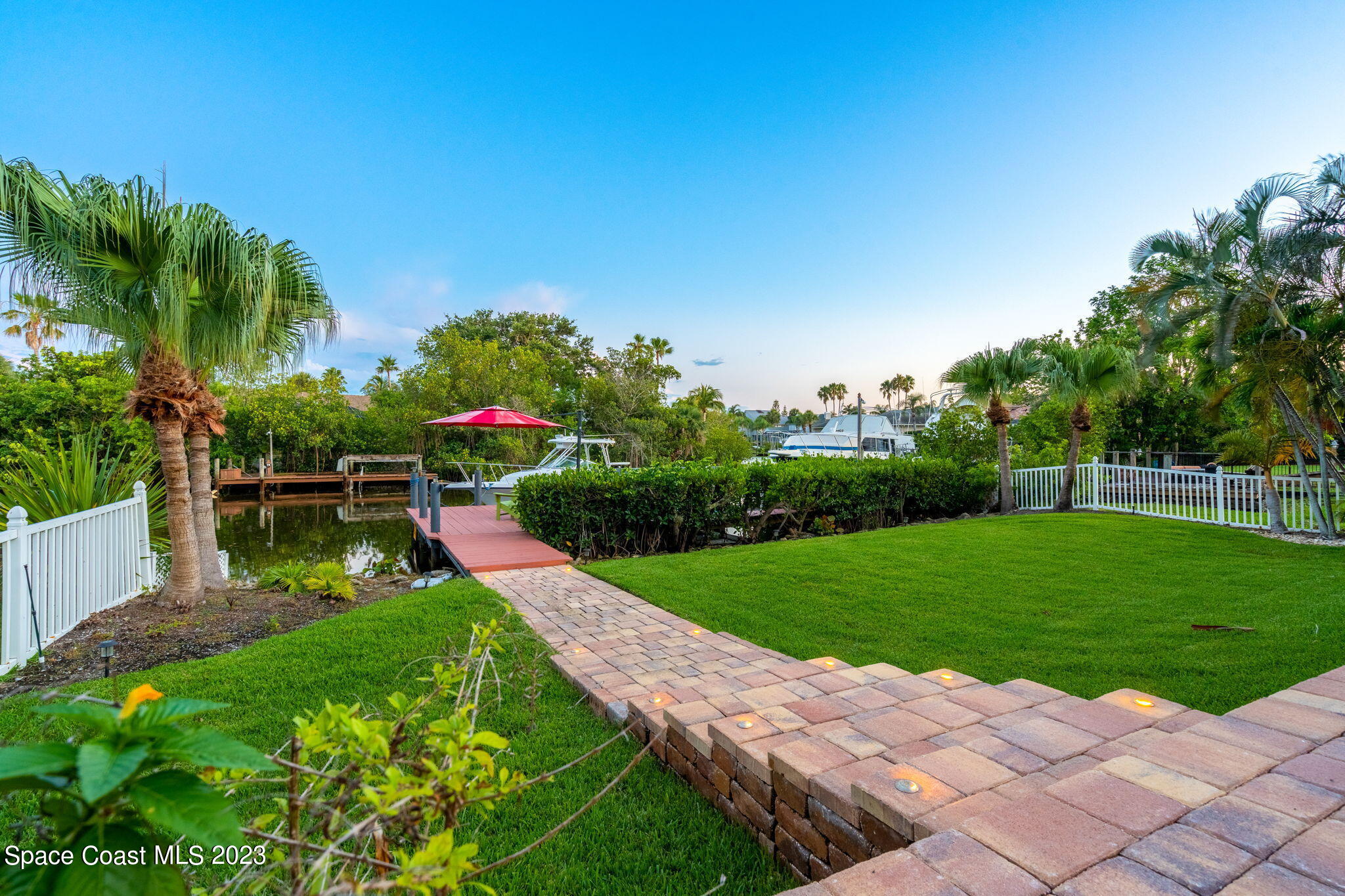 70 Lanternback Island Drive Satellite Beach, FL 32937 - Photo 20 of 26 a view of a garden with a bench