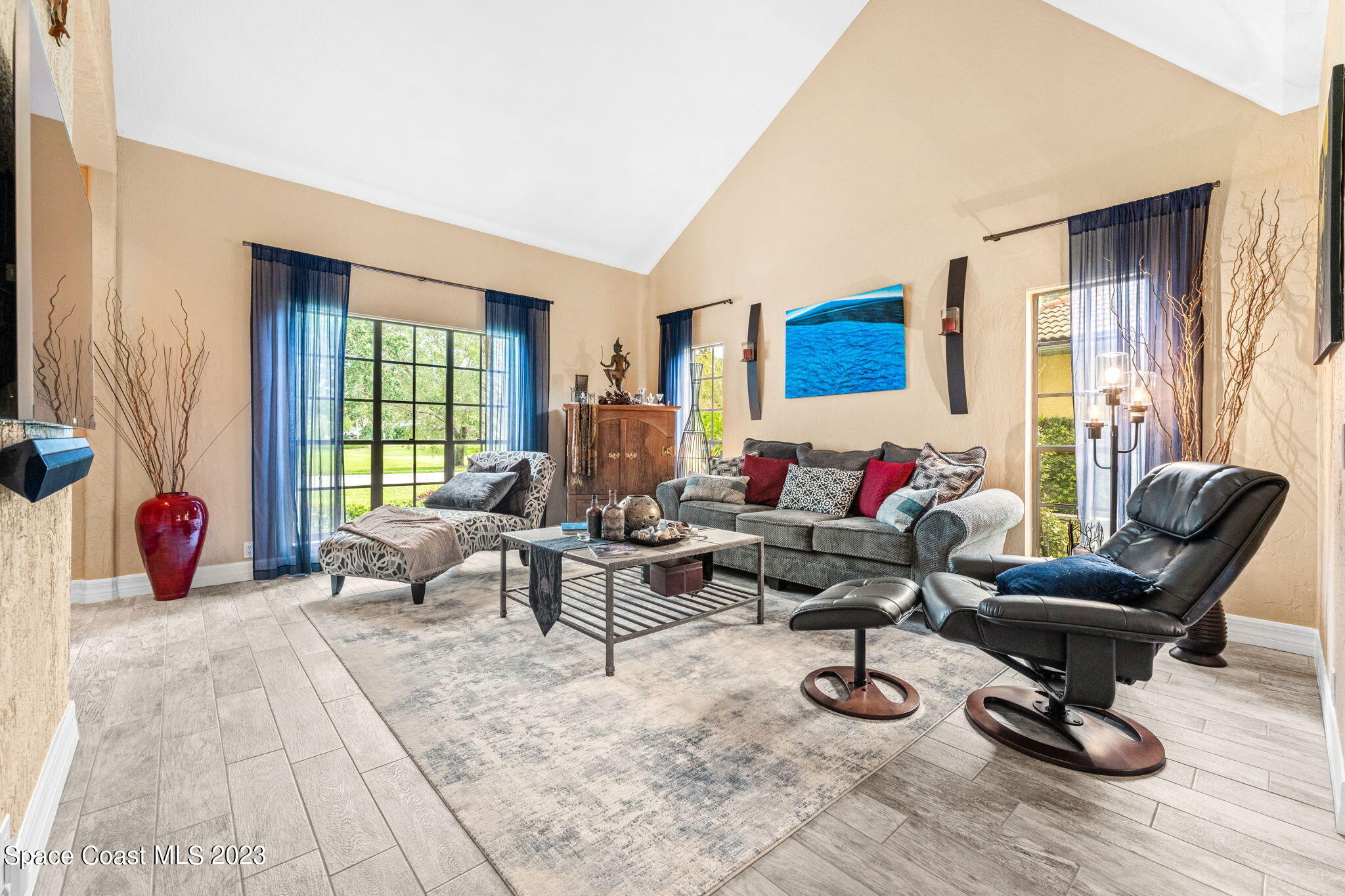 70 Lanternback Island Drive Satellite Beach, FL 32937 - Photo 3 of 26 a living room with furniture a rug and a large window
