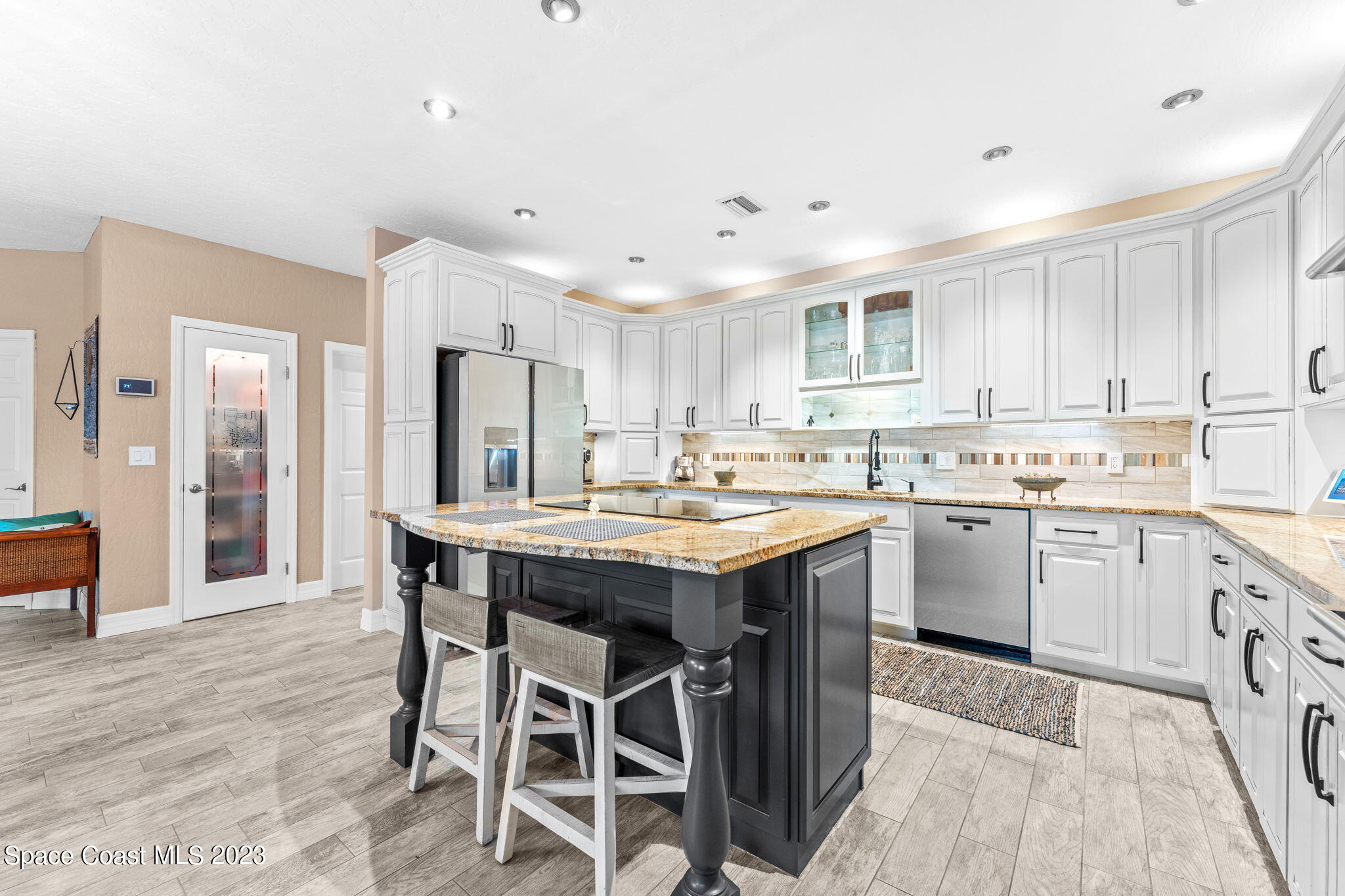 70 Lanternback Island Drive Satellite Beach, FL 32937 - Photo 5 of 26 a kitchen with granite countertop a sink counter top space and stainless steel appliances