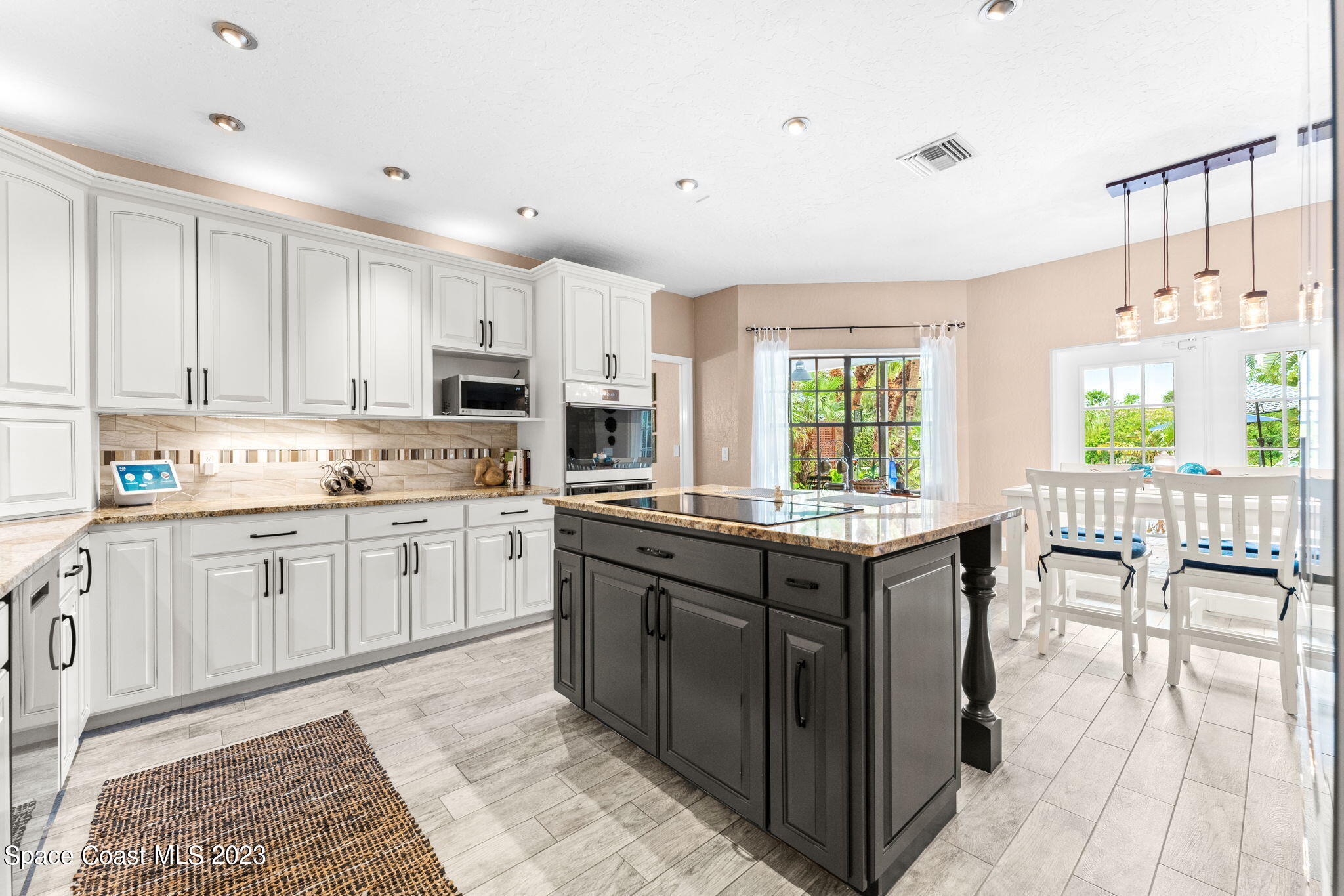 70 Lanternback Island Drive Satellite Beach, FL 32937 - Photo 6 of 26 a kitchen with granite countertop a sink and cabinets