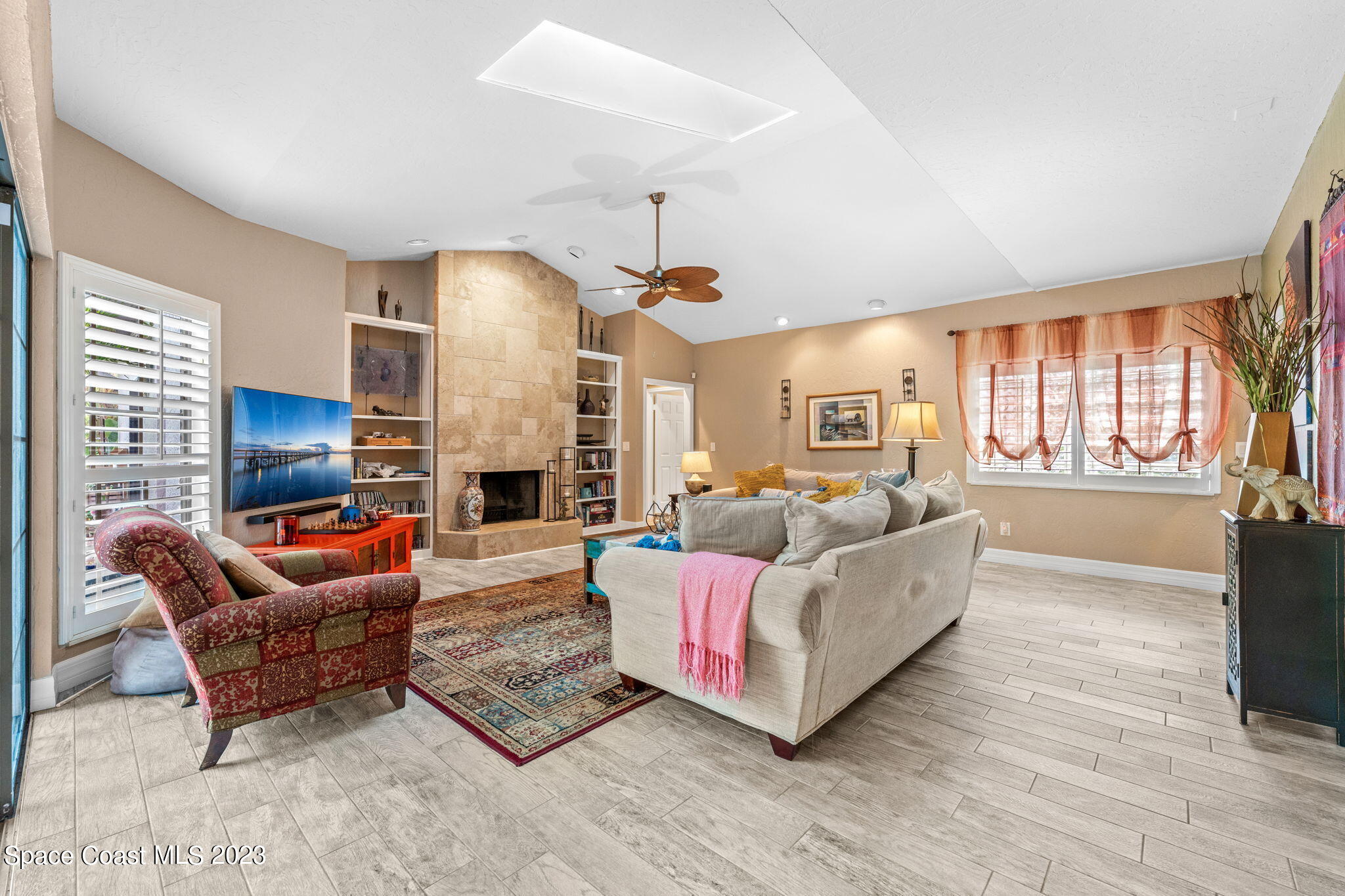 70 Lanternback Island Drive Satellite Beach, FL 32937 - Photo 7 of 26 a living room with fireplace furniture and a wooden floor