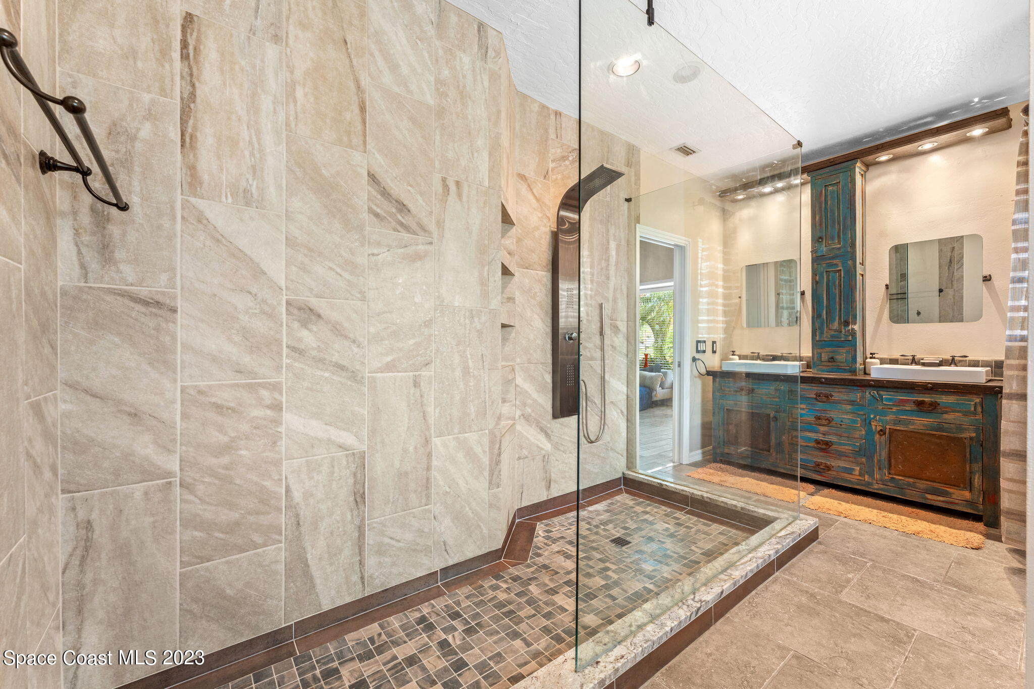 70 Lanternback Island Drive Satellite Beach, FL 32937 - Photo 10 of 26 a bathroom with a granite countertop sink a mirror and a shower