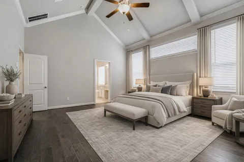 a spacious bedroom with a bed a couch and a ceiling fan