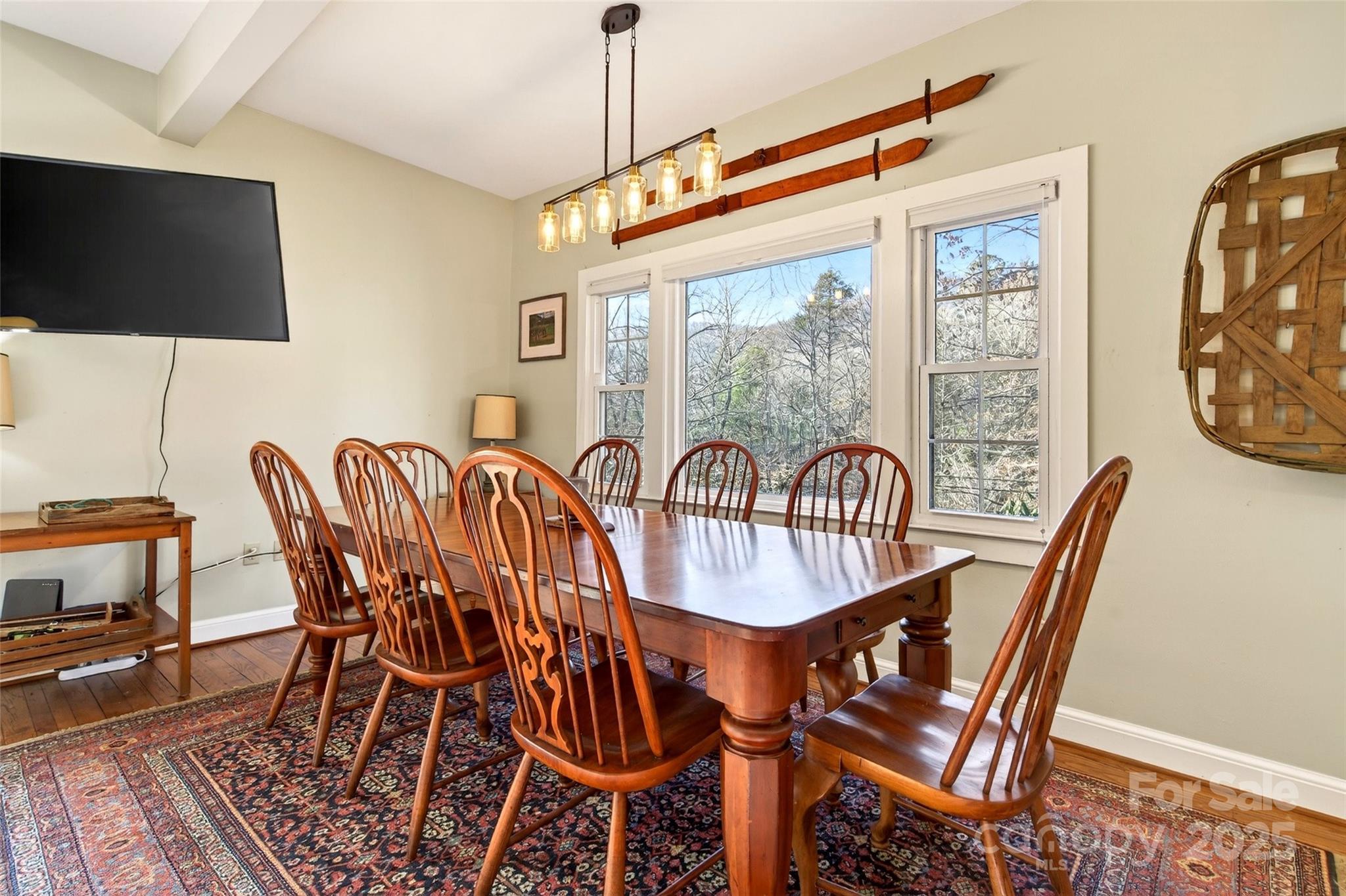 308 Texas Road Montreat, NC 28711 - Photo 13 of 48 a dining room with furniture a flat screen tv and a large window
