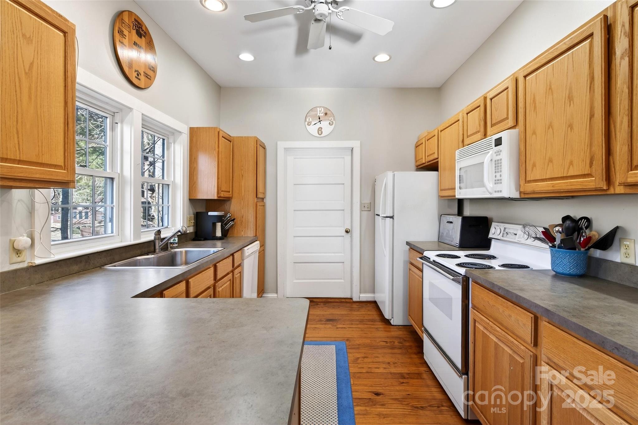 308 Texas Road Montreat, NC 28711 - Photo 15 of 48 a large kitchen with stainless steel appliances granite countertop a stove a sink dishwasher and a refrigerator with wooden floor