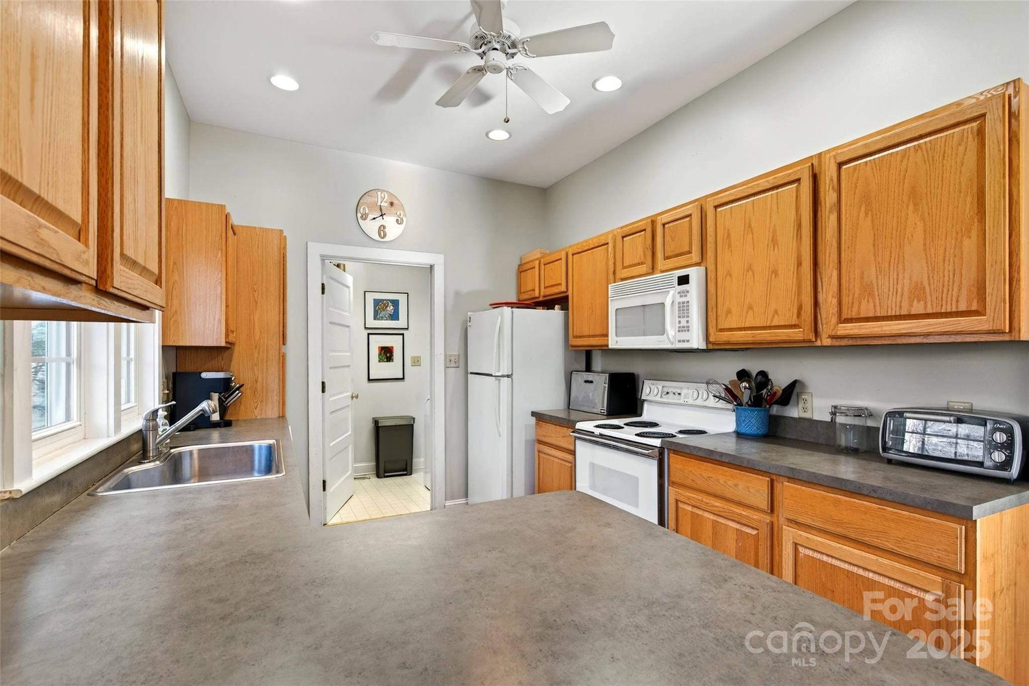 308 Texas Road Montreat, NC 28711 - Photo 16 of 48 a kitchen with stainless steel appliances granite countertop a refrigerator a oven a sink dishwasher and white cabinets with wooden floor