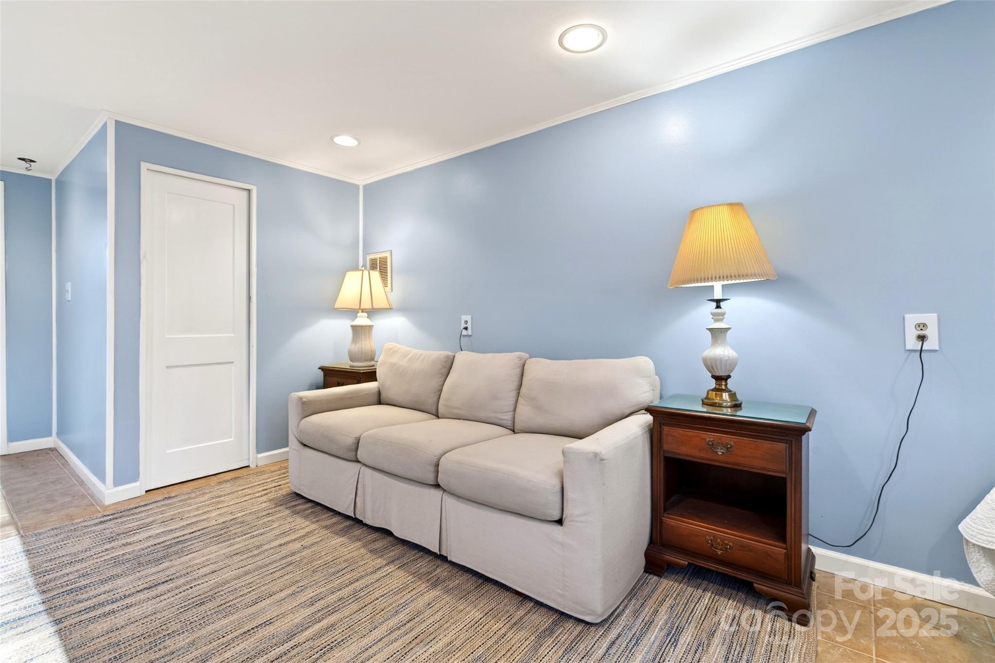 308 Texas Road Montreat, NC 28711 - Photo 38 of 48 a living room with a couch and a lamp on dresser with wooden floor