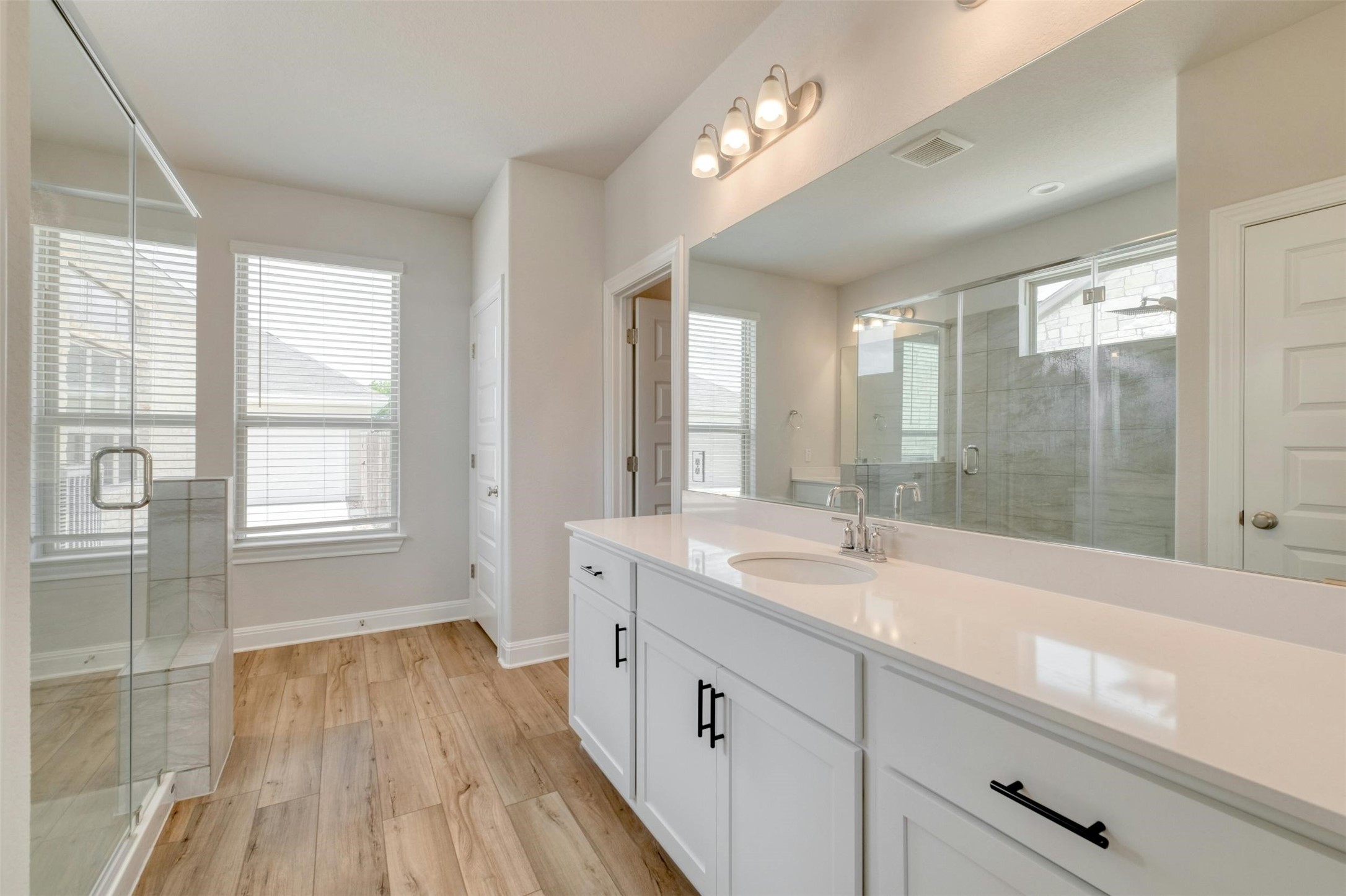 228 Rieber Road Kyle, TX 78640 - Photo 14 of 27 a spacious bathroom with a granite countertop sink mirror and double