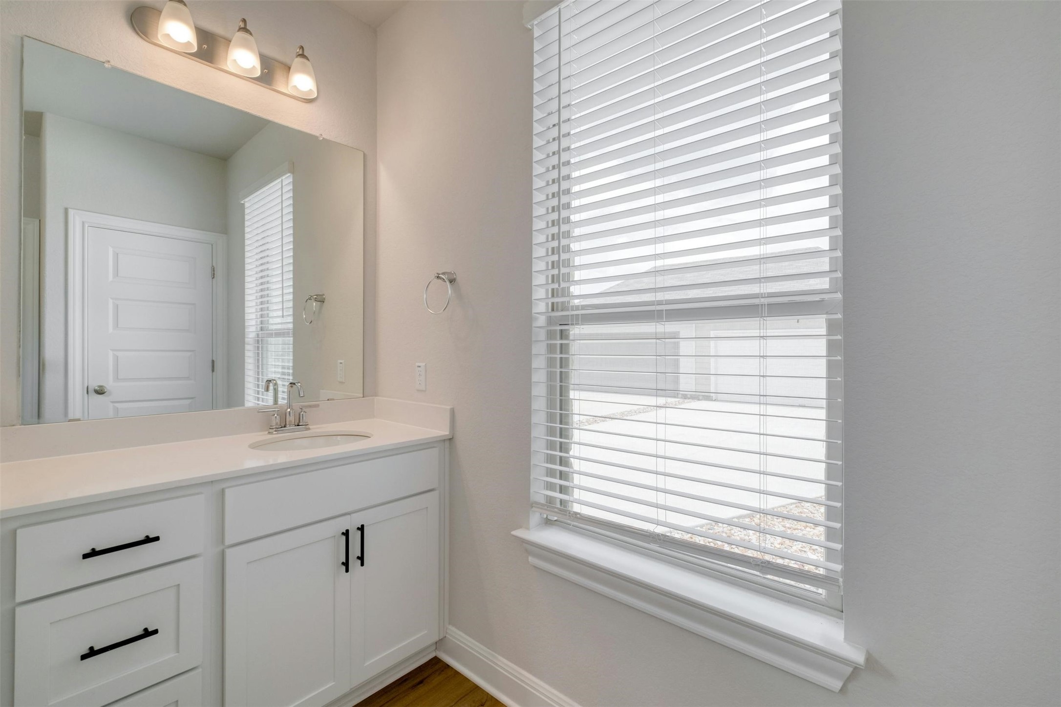 228 Rieber Road Kyle, TX 78640 - Photo 15 of 27 a bathroom with a sink a mirror and a window