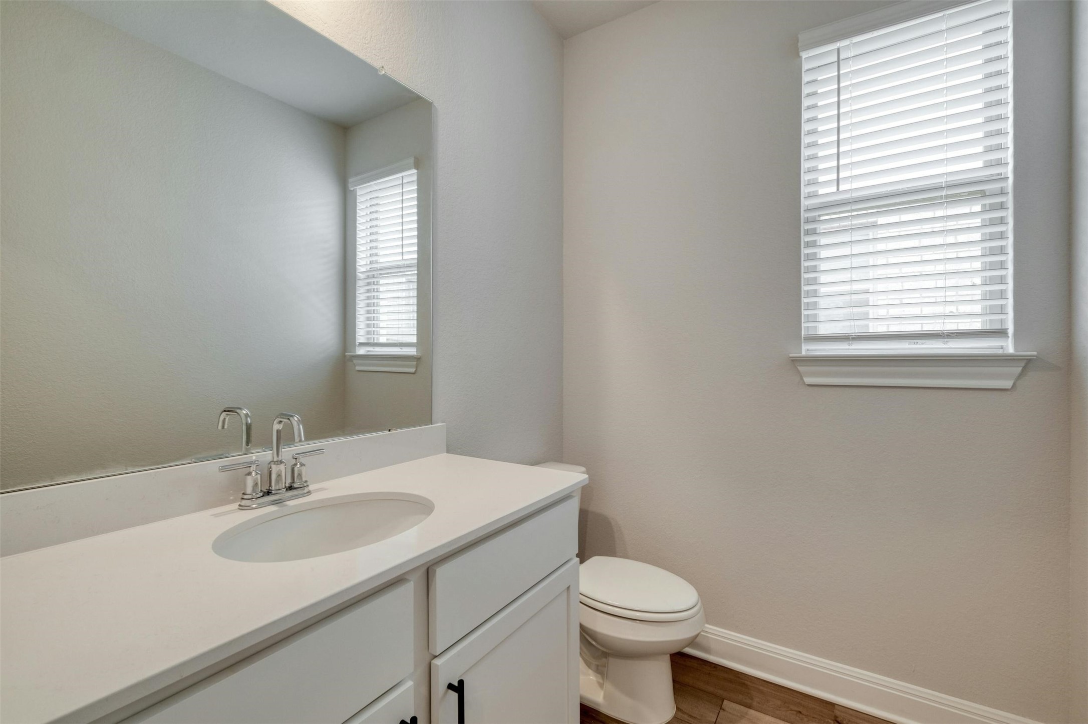 228 Rieber Road Kyle, TX 78640 - Photo 19 of 27 a bathroom with a sink a toilet and a window