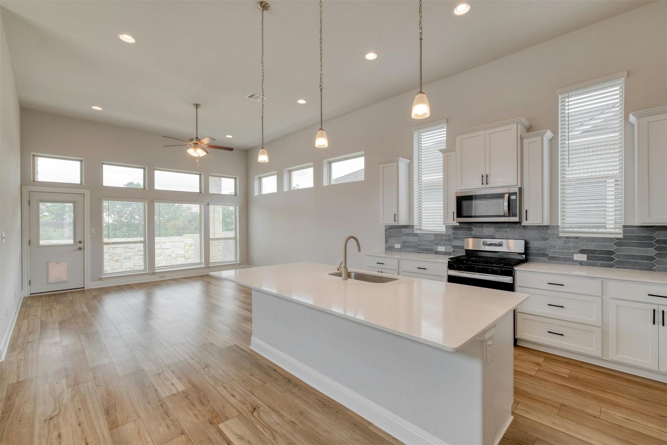228 Rieber Road Kyle, TX 78640 - Photo 2 of 27 a kitchen with counter top space a sink and appliances