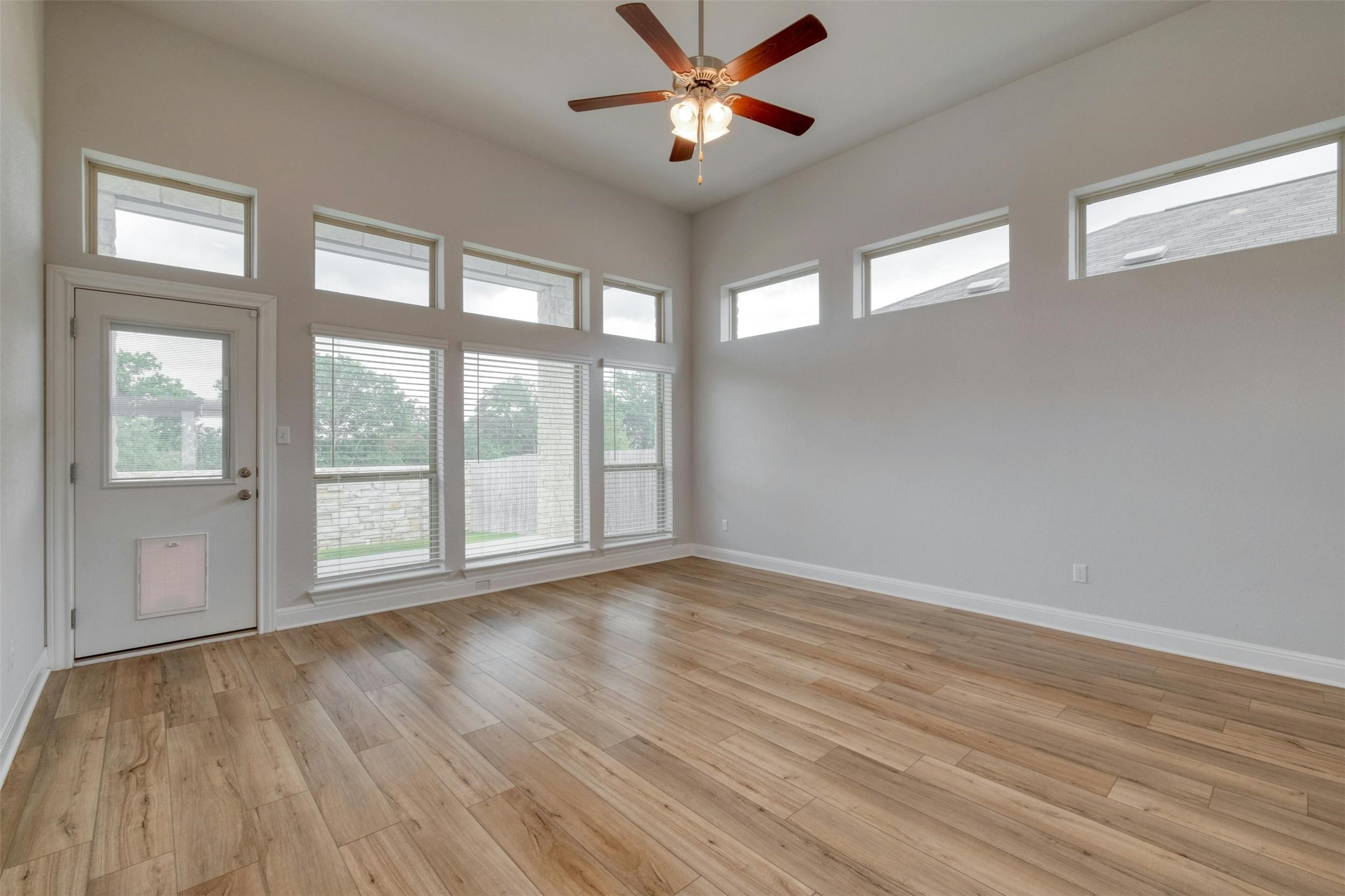 228 Rieber Road Kyle, TX 78640 - Photo 6 of 27 a view of an empty room with wooden floor and a window
