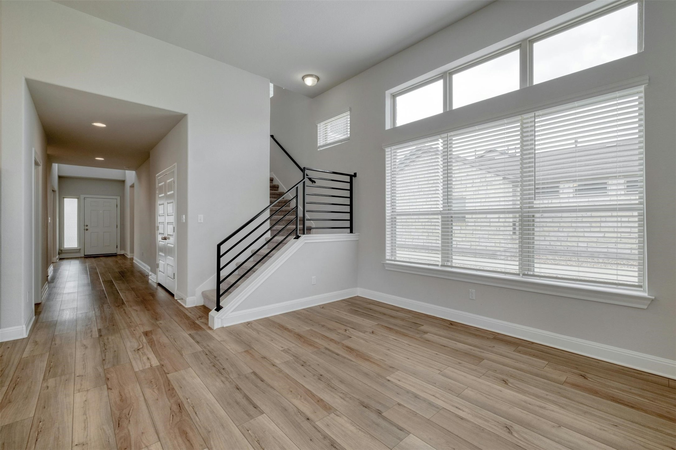 228 Rieber Road Kyle, TX 78640 - Photo 8 of 27 wooden floor in an empty room with a window