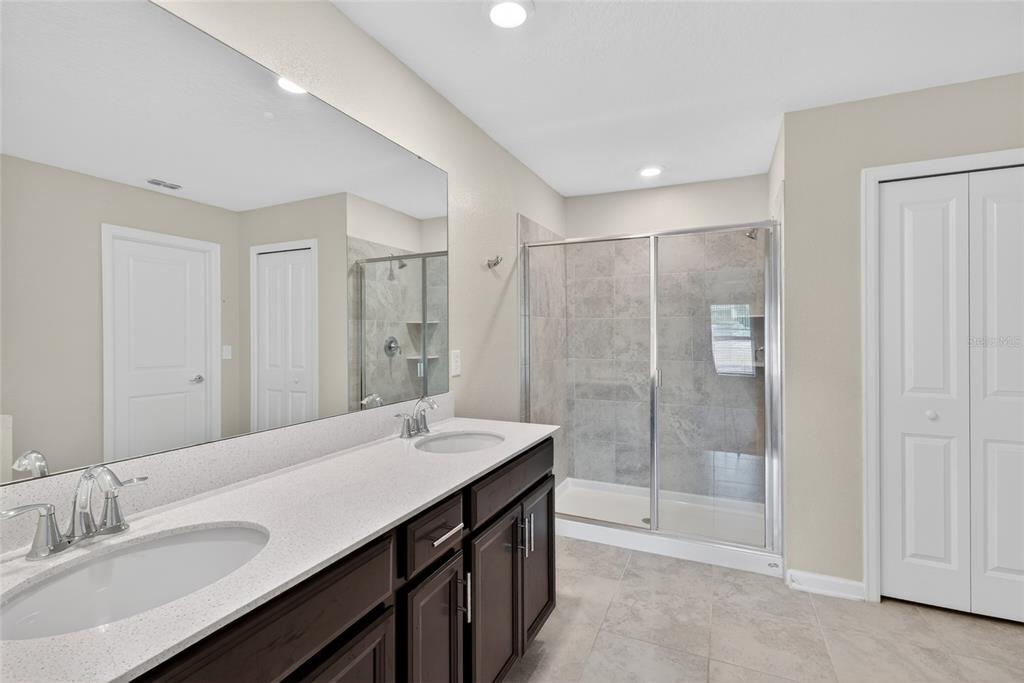 4773 Magnetite Loop Mount Dora, FL 32757 - Photo 8 of 36 a bathroom with a shower sink and mirror