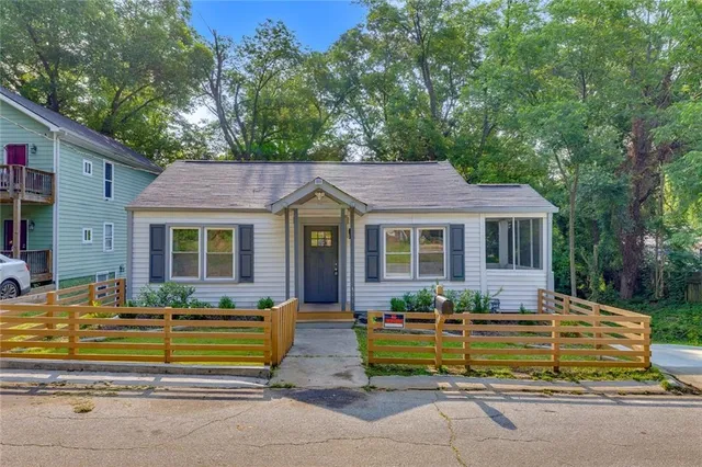 a front view of a house with a garden