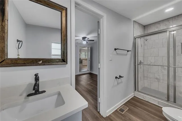 a bathroom with a shower and a sink