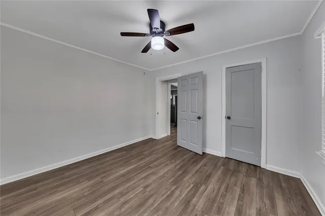 a view of empty room with wooden floor