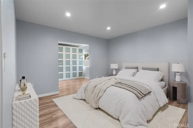 a bedroom with a large bed and a window