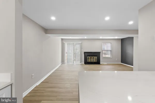 a view of an empty room with a fireplace