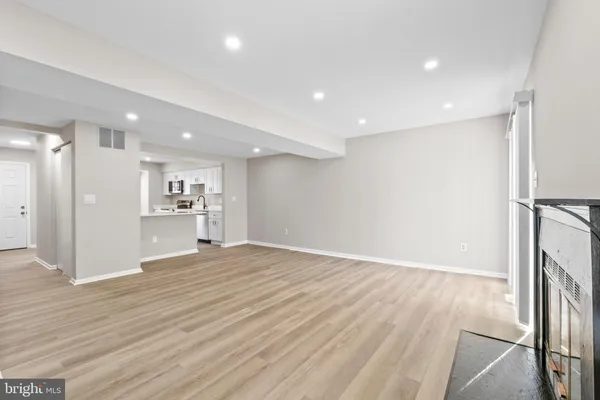 a view of a kitchen with a sink and wooden floor