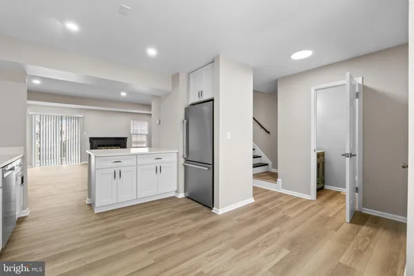 a kitchen with a refrigerator and a stove top oven