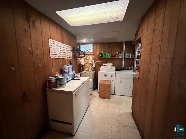 38 Locust Drive Babbitt, MN 55706 - Photo 17 of 29 Laundry area with washing machine and clothes dryer and wooden walls