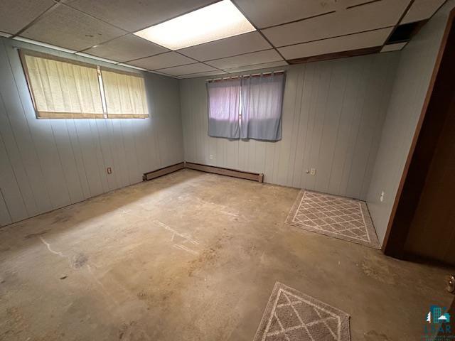 38 Locust Drive Babbitt, MN 55706 - Photo 19 of 29 Spare room featuring baseboard heating, unfinished concrete floors, and a paneled ceiling