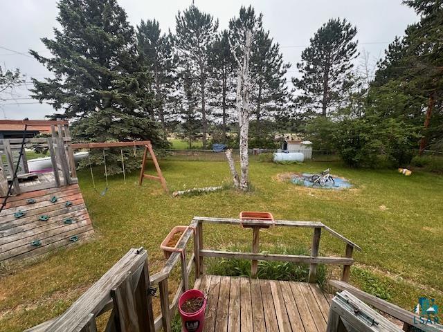 38 Locust Drive Babbitt, MN 55706 - Photo 22 of 29 View of green lawn featuring a playground and a wooden deck