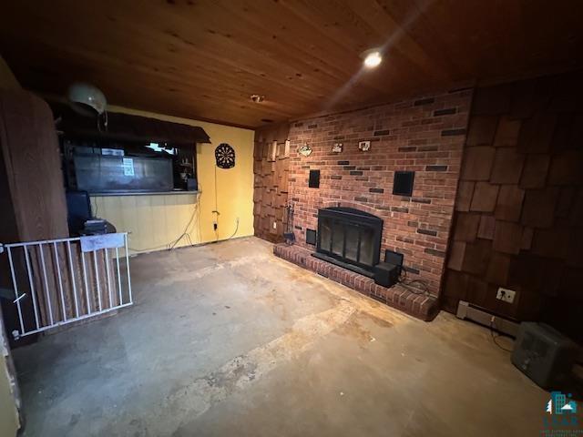 38 Locust Drive Babbitt, MN 55706 - Photo 9 of 29 Unfurnished living room featuring a fireplace, unfinished concrete flooring, wood ceiling, and a baseboard heating unit