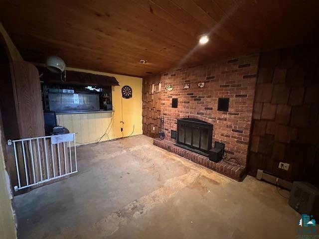 38 Locust Drive Babbitt, MN 55706 - Photo 10 of 29 Unfurnished living room featuring unfinished concrete flooring, a fireplace, and wood ceiling