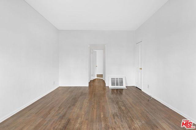 a view of a room with wooden floor