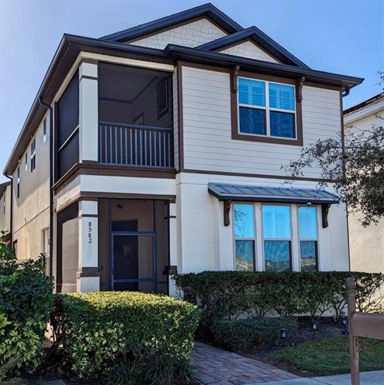 a view of a house with brick walls and flower plants