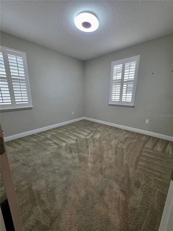 8582 Powder Ridge Trail Windermere, FL 34786 - Photo 19 of 50 an empty room with windows