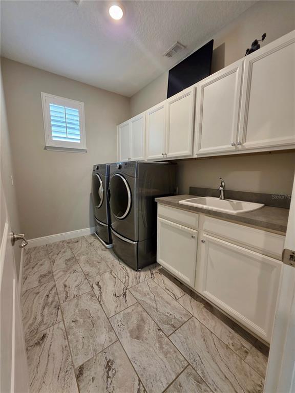 8582 Powder Ridge Trail Windermere, FL 34786 - Photo 23 of 50 a kitchen with a sink and cabinets