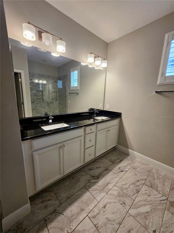 8582 Powder Ridge Trail Windermere, FL 34786 - Photo 27 of 50 a kitchen with a sink and cabinets