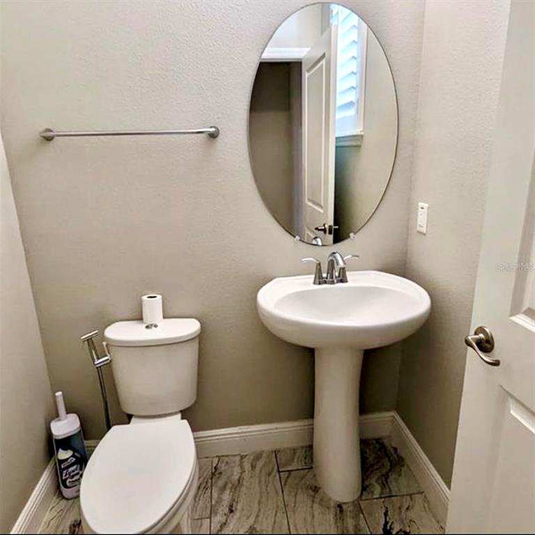 8582 Powder Ridge Trail Windermere, FL 34786 - Photo 29 of 50 a bathroom with a toilet sink and mirror