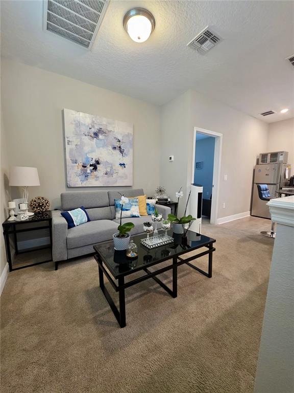 8582 Powder Ridge Trail Windermere, FL 34786 - Photo 37 of 50 a living room with furniture and a table