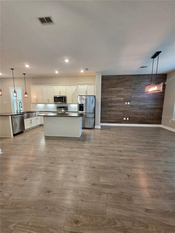 8582 Powder Ridge Trail Windermere, FL 34786 - Photo 5 of 50 a view of a kitchen with kitchen island a sink stainless steel appliances and cabinets