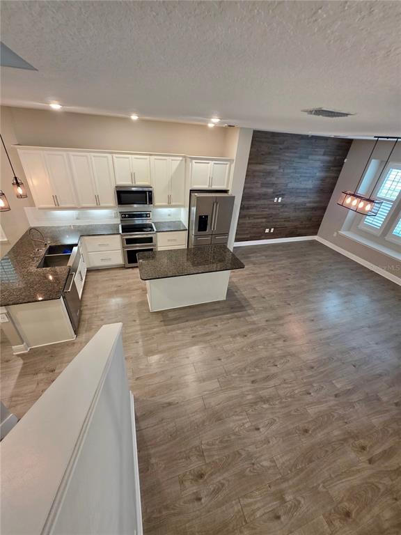 8582 Powder Ridge Trail Windermere, FL 34786 - Photo 7 of 50 a view of kitchen with stainless steel appliances wooden floor and living room