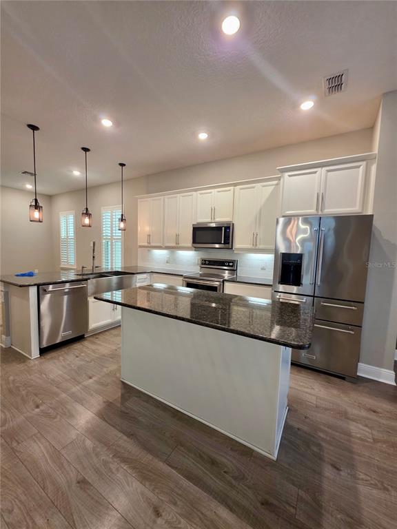 8582 Powder Ridge Trail Windermere, FL 34786 - Photo 8 of 50 a large kitchen with stainless steel appliances granite countertop a refrigerator and a stove top oven