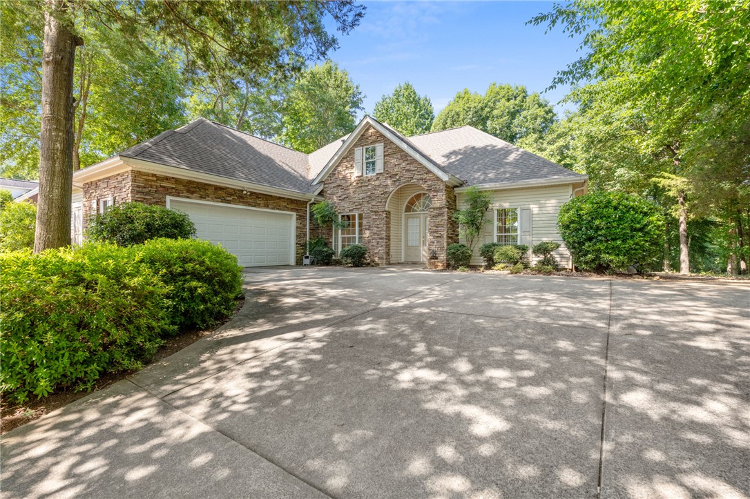 108 Winterbrook Circle Seneca, SC 29678 - Photo 5 of 40 Mature trees frame this elegant facade with a convenient attached garage.