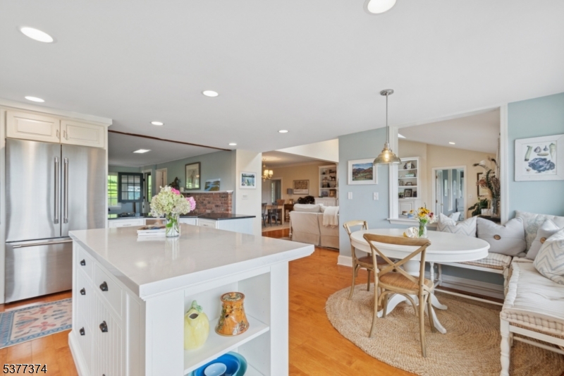 23 Spring Hill Road Annandale, NJ 08801 - Photo 12 of 48 a kitchen with a dining table chairs sink and wooden floor