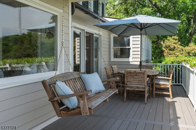 a bedroom with furniture and large windows