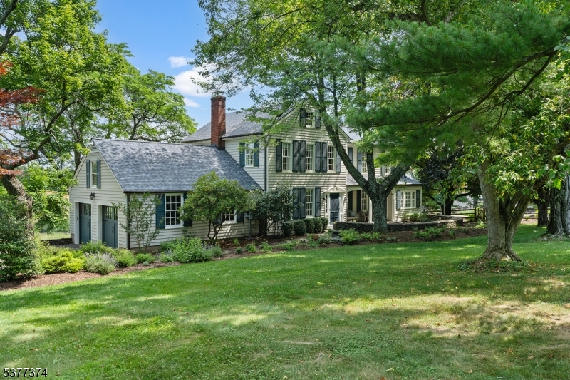 23 Spring Hill Road Annandale, NJ 08801 - Photo 3 of 48 a view of a big house with a big yard and large trees