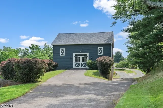 a living room with furniture a flat screen tv and a large window