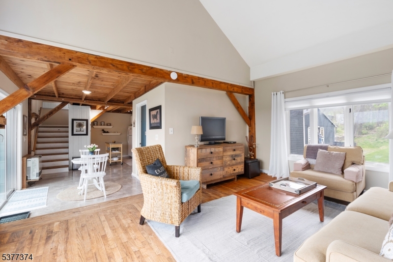 23 Spring Hill Road Annandale, NJ 08801 - Photo 42 of 48 a living room with furniture a flat screen tv and a large window