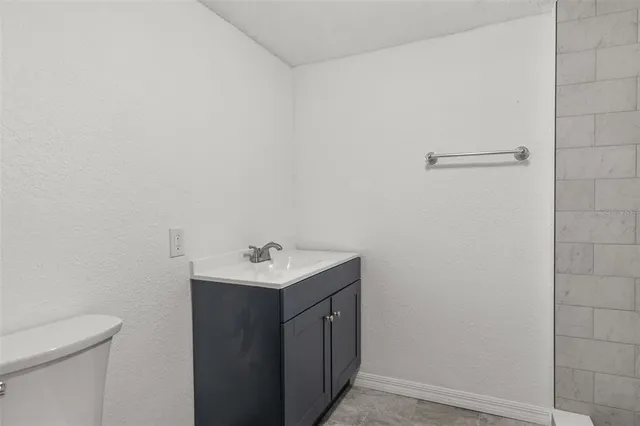 a bathroom with a sink a toilet and mirror