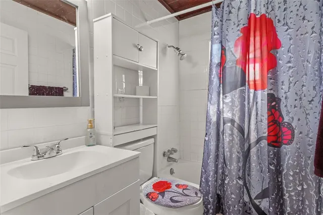 a bathroom with a sink and a shower curtain